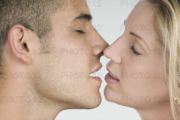 Close up of Hispanic couple kissing