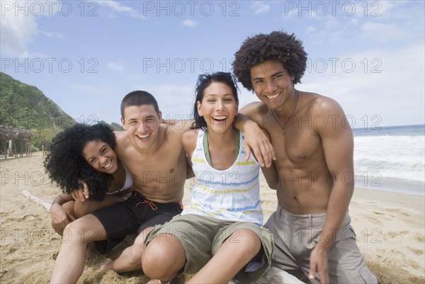 Multi-ethnic friends hugging at beach