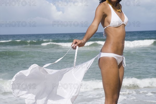 African woman in bikini at beach