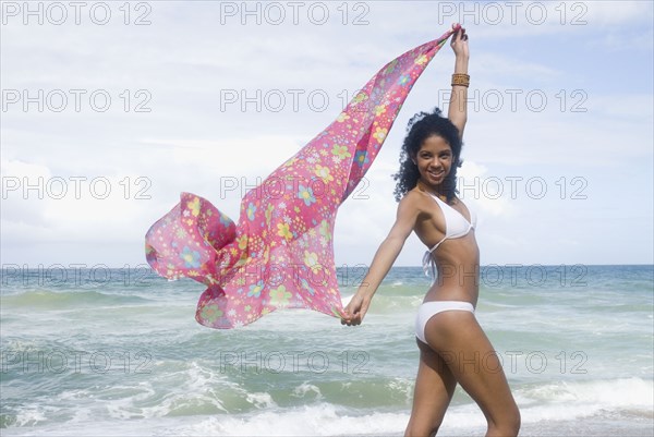 African woman in bikini at beach