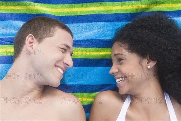 Multi-ethnic couple relaxing at beach