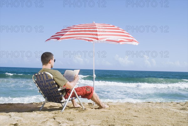 Hispanic teenager relaxing at beach