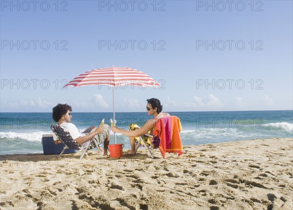 Multi-ethnic couple relaxing at beach