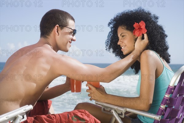 Multi-ethnic couple relaxing at beach