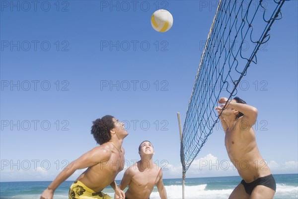 Friends playing volleyball at beach