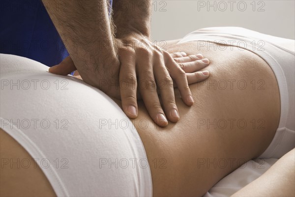 Chiropractor adjusting woman's back