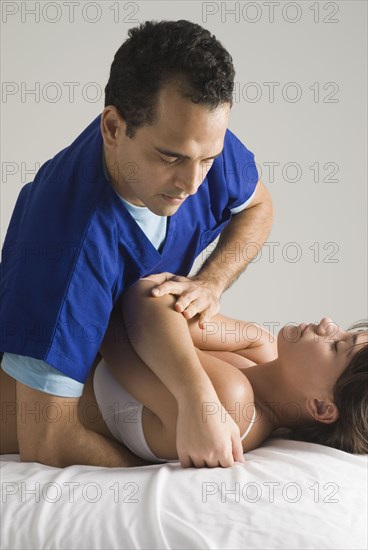 Chiropractor adjusting woman's back