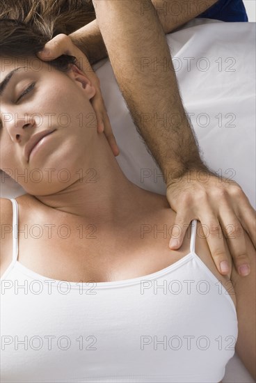 Chiropractor adjusting woman's neck