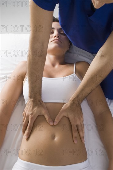 Chiropractor adjusting woman's spine