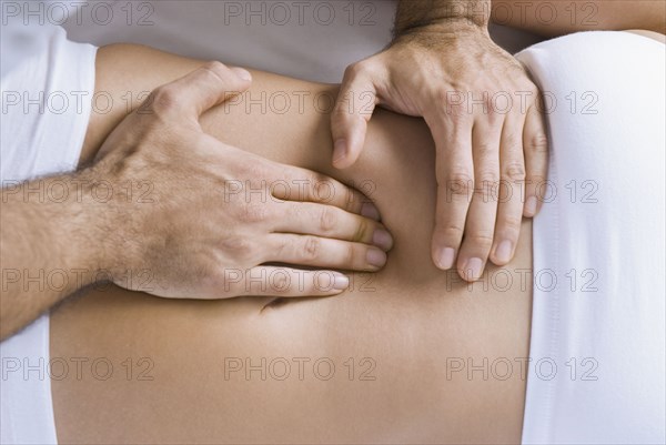 Chiropractor adjusting woman's spine