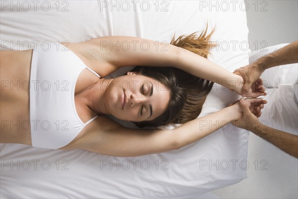 Chiropractor adjusting woman's spine