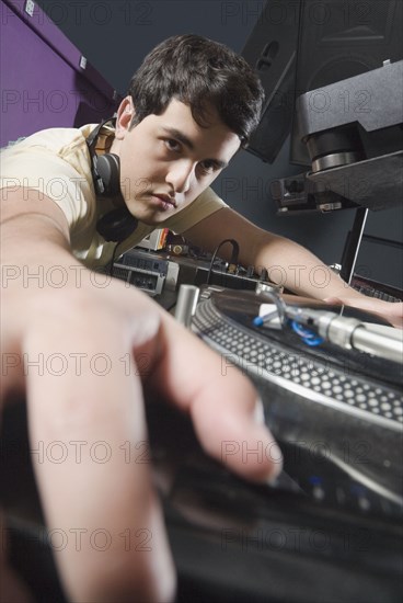 Hispanic DJ performing in nightclub