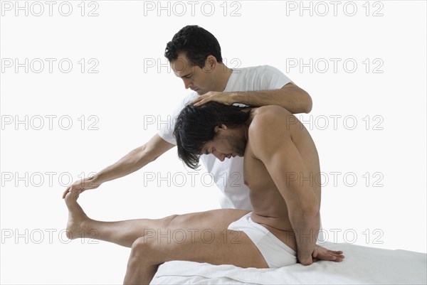 Chiropractor adjusting man's back