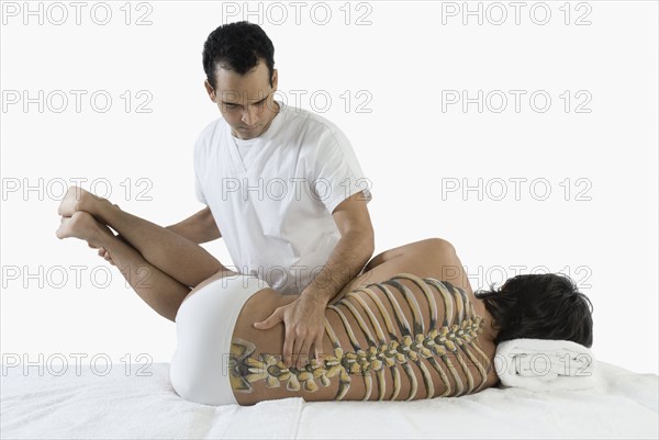 Chiropractor adjusting man's back