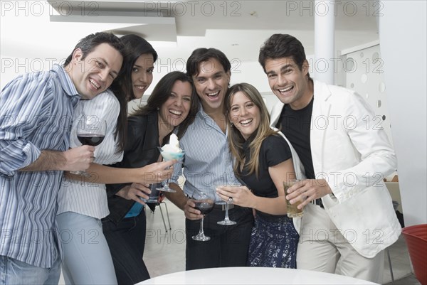 Hispanic friends drinking cocktails