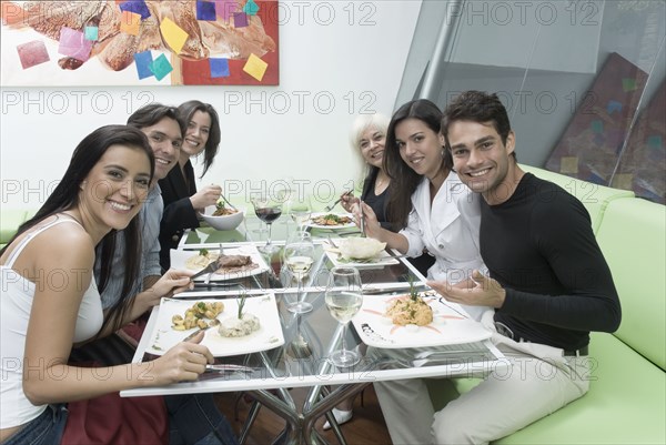 Hispanic friends eating in restaurant