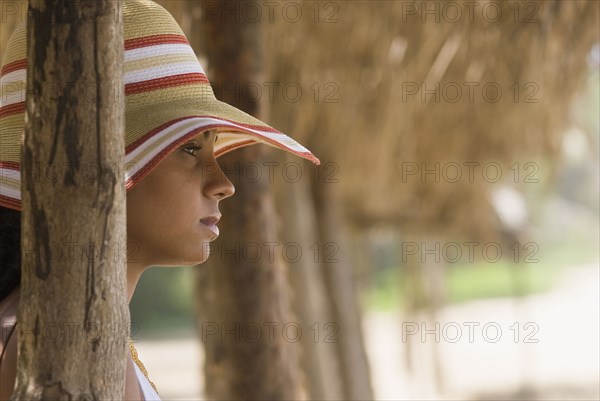 African woman in sunhat at beach