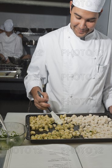 Baker working in bakery kitchen