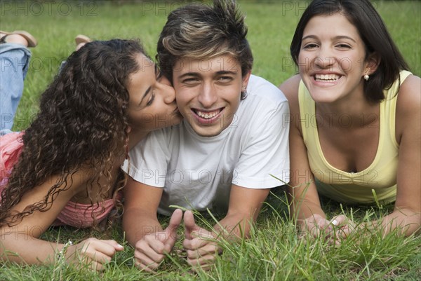 Hispanic girl kissing man on cheek