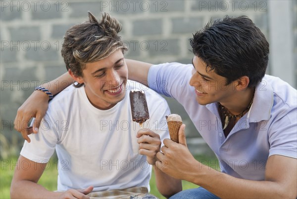 Hispanic men eating ice cream together