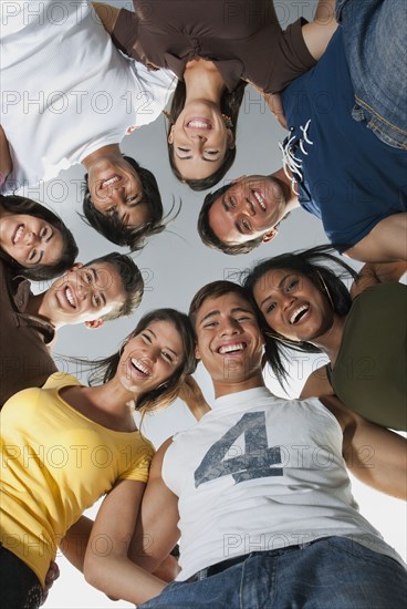 Smiling friends in huddle together