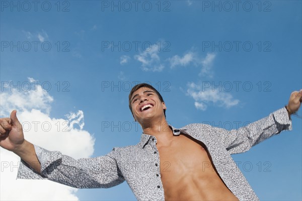 Smiling Caucasian man with shirt open