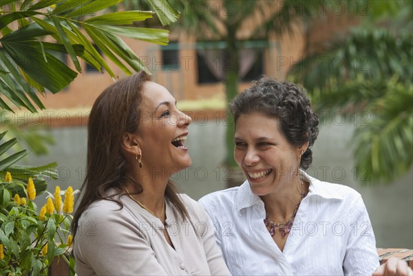 Hispanic women laughing together