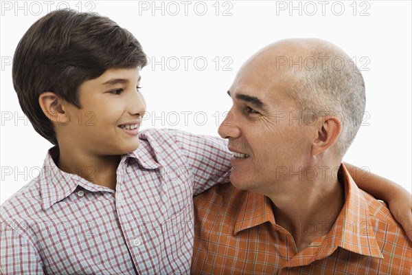 Hispanic father and son hugging