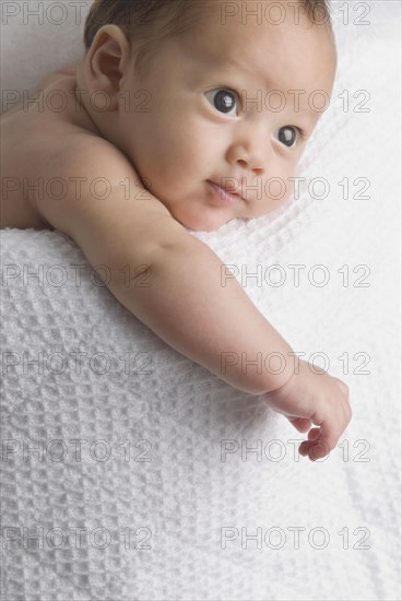 Curious baby laying in blanket