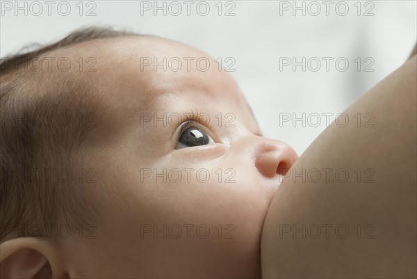 Close up of Hispanic baby breast feeding