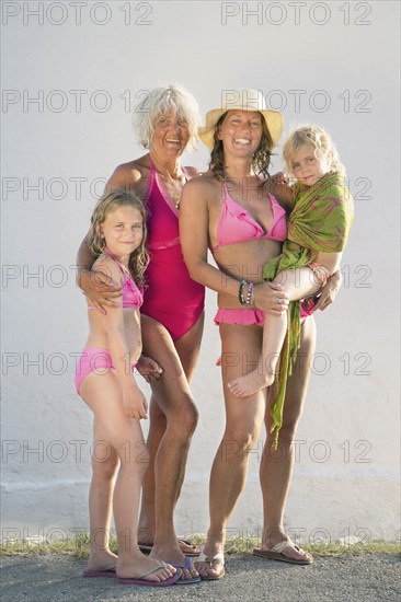 Three generations of Caucasian women smiling on beach