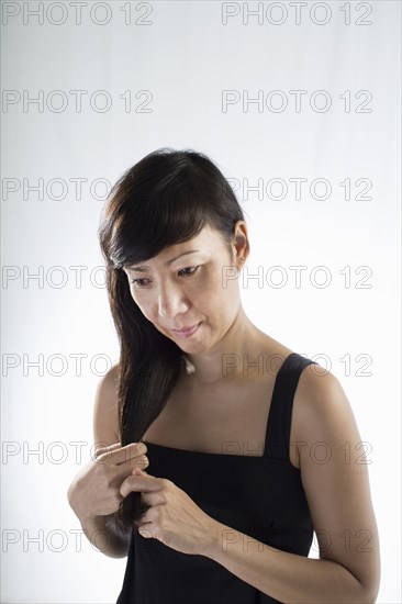 Mixed race woman twisting her hair
