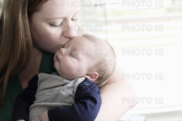 Mother kissing baby son