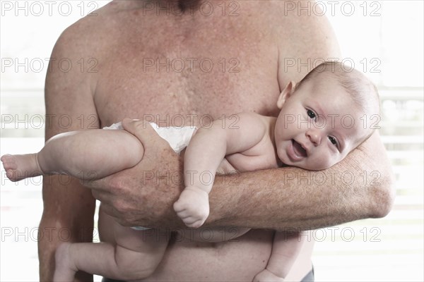 Father holding baby son