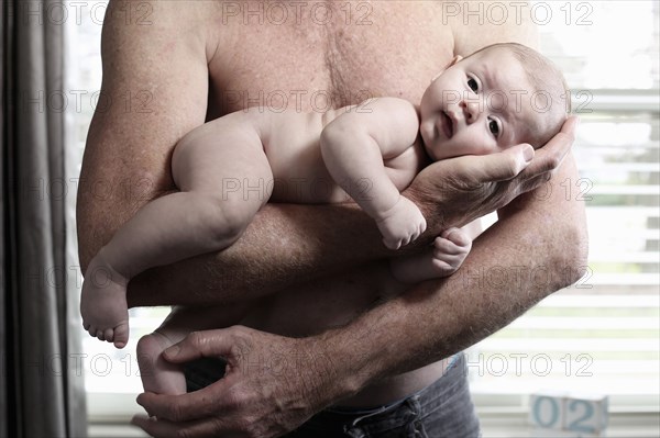 Father holding baby son