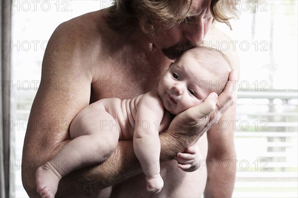 Father kissing baby son