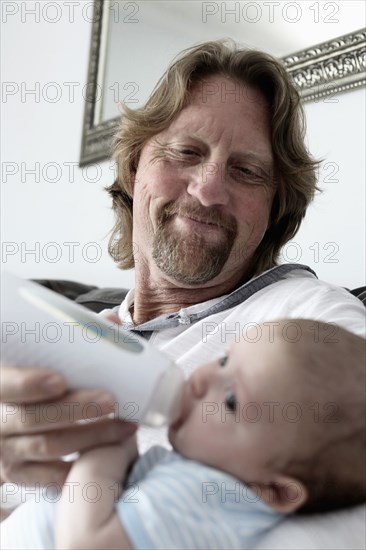 Father feeding baby son