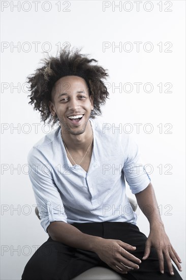 Mixed Race man sitting and laughing