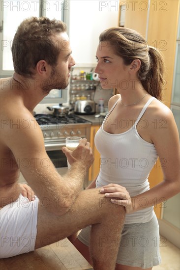 Caucasian couple in pajamas in kitchen