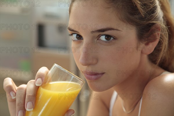 Caucasian woman drinking orange juice