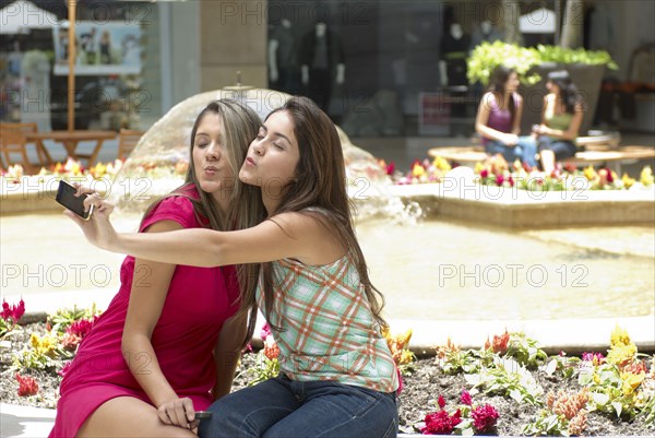 Hispanic friends taking self-portrait