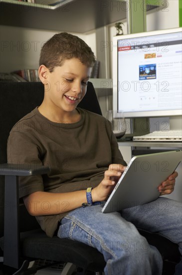 Hispanic boy using digital tablet