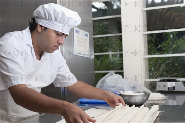 Hispanic baker working in commercial kitchen