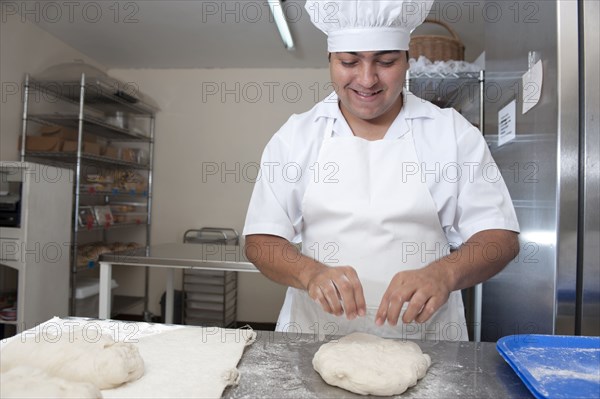 Hispanic baker working in commercial kitchen