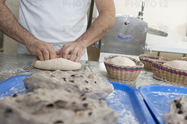 Hispanic baker working in commercial kitchen