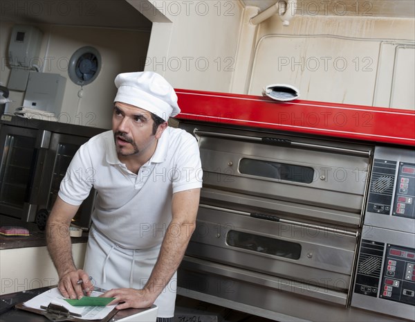 Hispanic baker working in commercial kitchen