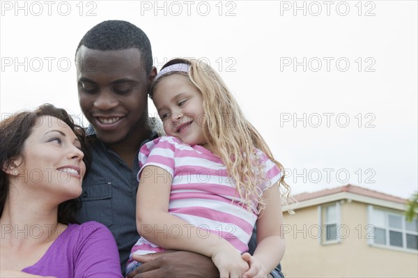 Smiling family hugging outdoors