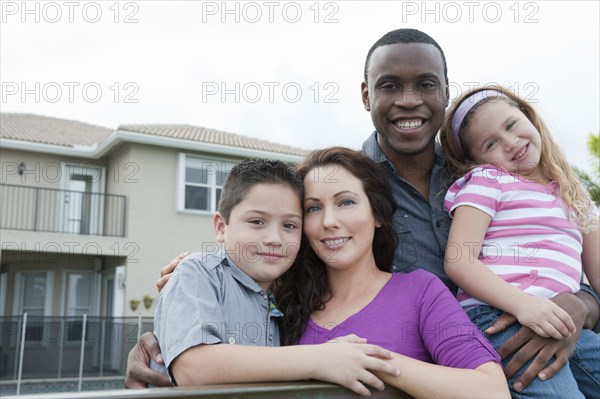 Smiling family hugging outdoors