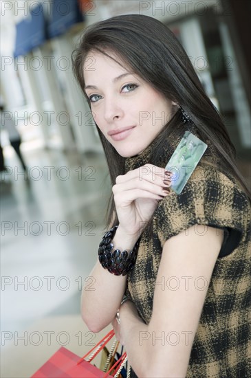 Hispanic woman holding credit card