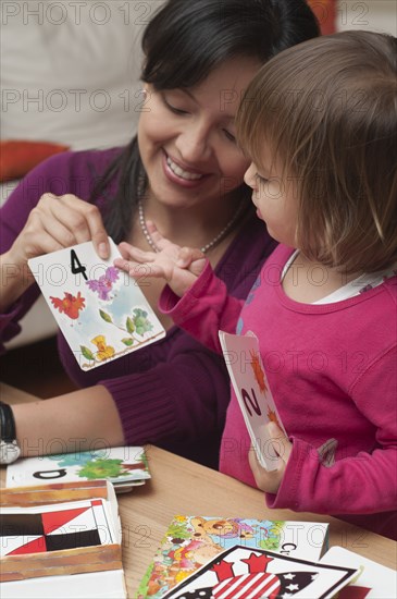 Hispanic mother teaching daughter numbers